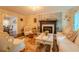 Comfortable living room with a brick fireplace, patterned wallpaper, and classic furnishings at 5293 Sandy Shoals Ln, Stone Mountain, GA 30087