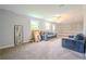 Large living room with neutral carpet and paint, offering a versatile space for relaxation and entertainment at 5293 Sandy Shoals Ln, Stone Mountain, GA 30087