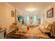 Elegant living room featuring a fireplace, patterned wallpaper, chandelier, and ornate furniture at 5293 Sandy Shoals Ln, Stone Mountain, GA 30087