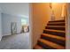 Living room with neutral carpet leading to staircase at 5293 Sandy Shoals Ln, Stone Mountain, GA 30087