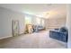 Spacious living room with neutral walls and carpet, filled with natural light from the windows at 5293 Sandy Shoals Ln, Stone Mountain, GA 30087