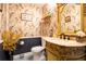 Stylish powder room featuring patterned wallpaper, elegant vanity with marble countertop, and modern fixtures at 5293 Sandy Shoals Ln, Stone Mountain, GA 30087
