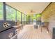 View of the spacious screened porch, ceiling fan, and furniture at 5293 Sandy Shoals Ln, Stone Mountain, GA 30087