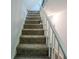 Carpeted stairs with white railing lead to the upper level, creating a seamless transition between floors at 5293 Sandy Shoals Ln, Stone Mountain, GA 30087