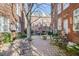 Charming brick courtyard with seating, greenery, and access gate at 690 Piedmont Ne Ave # 17, Atlanta, GA 30308