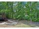 Backyard features a wooden deck, stone pathway, and serene natural surroundings at 765 Brooks Cir, Stone Mountain, GA 30087