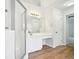 Elegant bathroom with a walk-in shower, wooden floors, and a large vanity at 765 Brooks Cir, Stone Mountain, GA 30087