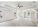 Spacious bedroom with tray ceilings, windows, recessed lighting, and built-in shelving at 765 Brooks Cir, Stone Mountain, GA 30087