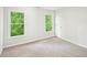 This bedroom features neutral carpet, natural light, and a standard closet at 765 Brooks Cir, Stone Mountain, GA 30087