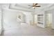 Large bedroom with tray ceilings, recessed lighting, and windows offering natural light at 765 Brooks Cir, Stone Mountain, GA 30087