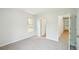 A neutrally decorated bedroom featuring a window and access to the hallway at 765 Brooks Cir, Stone Mountain, GA 30087