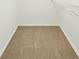 Walk-in closet features neutral carpeting and a shelf for added storage at 765 Brooks Cir, Stone Mountain, GA 30087