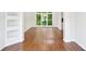 Bright room with hardwood flooring, large window, wainscotting, and built in shelves at 765 Brooks Cir, Stone Mountain, GA 30087