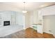 Open dining area featuring hardwood floors and ample natural light with fireplace in view at 765 Brooks Cir, Stone Mountain, GA 30087