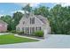 Well-manicured brick home featuring symmetrical design, mature landscaping, and a paved driveway at 765 Brooks Cir, Stone Mountain, GA 30087