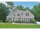 Charming brick home with manicured lawn, featuring symmetrical design, shutters, and mature landscaping at 765 Brooks Cir, Stone Mountain, GA 30087