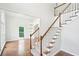 Bright foyer featuring hardwood floors, a staircase, and natural light from a large window at 765 Brooks Cir, Stone Mountain, GA 30087