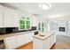 Bright kitchen featuring white cabinets, stainless steel appliances, and an island with a sink at 765 Brooks Cir, Stone Mountain, GA 30087