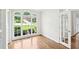 Bright living room featuring hardwood floors, large windows offering a view of the landscaped front yard at 765 Brooks Cir, Stone Mountain, GA 30087