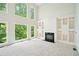 Bright living room with high ceilings, large windows, a fireplace, and built-in shelving at 765 Brooks Cir, Stone Mountain, GA 30087