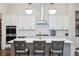 Stylish kitchen with center island, barstool seating, and stainless steel appliances at 114 Village Green Ave, Woodstock, GA 30189
