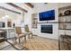 Spacious living room boasts beamed ceilings, fireplace, and built-in shelving at 114 Village Green Ave, Woodstock, GA 30189