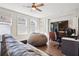 Comfortable living room features hardwood floors, modern ceiling fan, and a large beanbag chair at 114 Village Green Ave, Woodstock, GA 30189