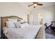 This main bedroom features a comfy king bed, ceiling fan, and lots of light from windows and a connecting bath at 114 Village Green Ave, Woodstock, GA 30189