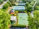 Aerial view showcasing the community amenities, including tennis courts, a playground, and green spaces at 3905 Merriweather Woods, Johns Creek, GA 30022
