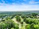 Beautiful aerial view of a lush golf course neighborhood with a mix of trees and well-manicured lawns at 3905 Merriweather Woods, Johns Creek, GA 30022