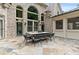 Spacious back patio with stone tiling and an outdoor dining area, perfect for entertaining guests at 3905 Merriweather Woods, Johns Creek, GA 30022