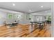 Spacious basement with a ping pong table, seating, and natural light, great for recreation and relaxation at 3905 Merriweather Woods, Johns Creek, GA 30022