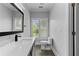Bathroom featuring a modern sink, toilet, and natural light from a large window at 3905 Merriweather Woods, Johns Creek, GA 30022