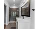 Modern bathroom showcasing a glass shower, dark fixtures, and a sleek white vanity at 3905 Merriweather Woods, Johns Creek, GA 30022