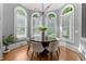 Dining room with a modern chandelier and many windows offering an abundance of natural light at 3905 Merriweather Woods, Johns Creek, GA 30022