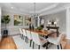 Formal dining room with hardwood floors, tray ceilings, and a modern chandelier at 3905 Merriweather Woods, Johns Creek, GA 30022
