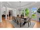 Elegant dining room with a dark wood table and natural light from many windows at 3905 Merriweather Woods, Johns Creek, GA 30022