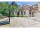 Long driveway view with a basketball hoop, sunroom, and two-car garage at 3905 Merriweather Woods, Johns Creek, GA 30022