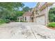 Long driveway view with a basketball hoop, sunroom, and two-car garage at 3905 Merriweather Woods, Johns Creek, GA 30022