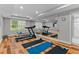 Bright exercise room features hardwood floors, a treadmill, and mirrored wall, perfect for fitness workouts at 3905 Merriweather Woods, Johns Creek, GA 30022