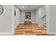 Inviting hallway features hardwood floors, a bench, and elegant decor, leading to other parts of the home at 3905 Merriweather Woods, Johns Creek, GA 30022