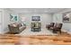 Living room with neutral walls, wood flooring, sofa, sitting chairs, and recessed lighting at 3905 Merriweather Woods, Johns Creek, GA 30022