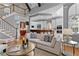 Living room with an open staircase, high ceilings, and natural light flowing into the kitchen at 3905 Merriweather Woods, Johns Creek, GA 30022