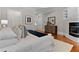 Luxurious main bedroom with hardwood floors, a comfortable bed, fireplace and a walk-in closet at 3905 Merriweather Woods, Johns Creek, GA 30022