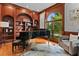 Cozy music room with wood paneling, a grand piano, and a large window at 3905 Merriweather Woods, Johns Creek, GA 30022