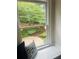 Cozy window seat with backyard view, complete with vibrant hydrangeas and a stone patio at 3905 Merriweather Woods, Johns Creek, GA 30022