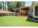 Spacious backyard with large porch, green lawn, and mature trees at 125 Sandridge Ct, Alpharetta, GA 30022