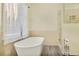 Bright bathroom featuring a glass walk-in shower and a freestanding bathtub with modern faucet at 125 Sandridge Ct, Alpharetta, GA 30022
