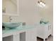 Bathroom featuring double glass bowl sinks with modern faucets and a vanity with glass top at 125 Sandridge Ct, Alpharetta, GA 30022