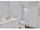 Bathroom featuring a walk-in shower with glass door, a light grey wall, and a white sink at 125 Sandridge Ct, Alpharetta, GA 30022